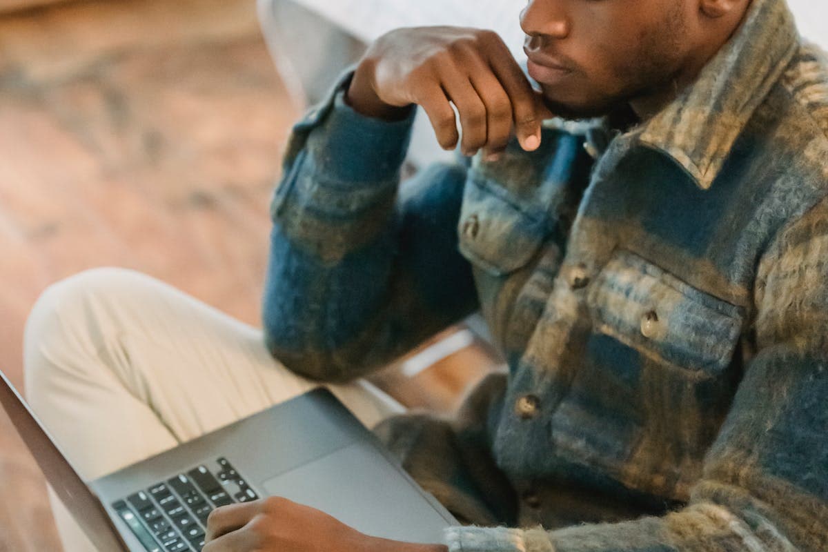 A young Cameroonian taking an online course on a phone — free courses and certifications